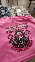 A pink graphic t-shirt featuring a skull with a pink bow and sunglasses, checkered patterns, and the text 'I WILL MURDER YOU' and 'JESUS ONE ONLY SHAPED BY GOD'.